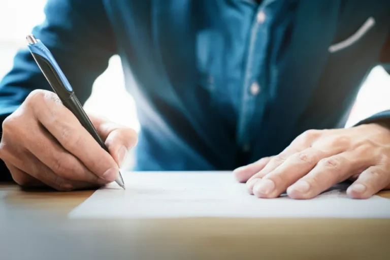 Client signing paperwork related to bail bond services.