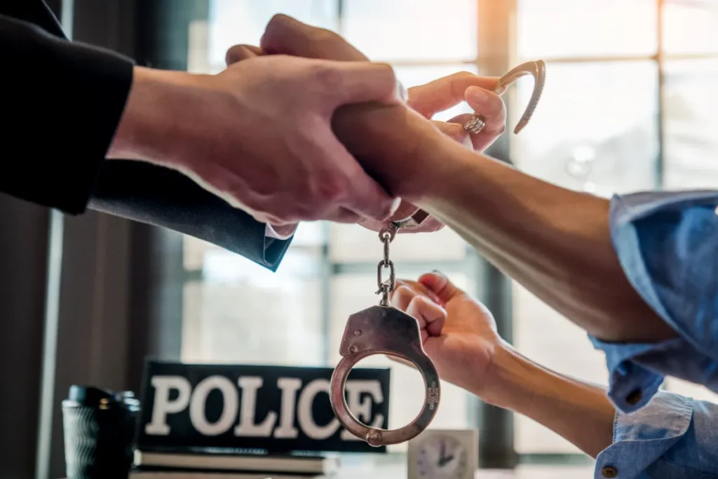 A man releasing the hand from a handcuffs.
