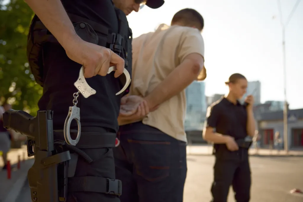 Patrol officers team arresting a male offender.