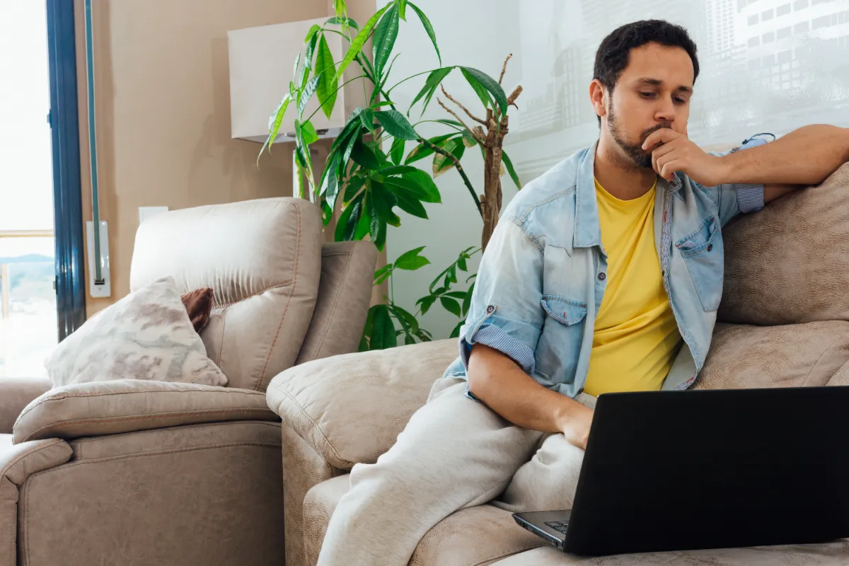Man using a computer to run a warrant check on a court website.